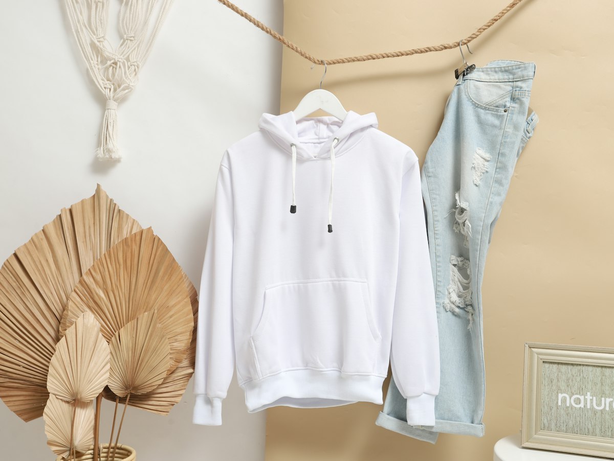 A plain white hoodie hanging on display