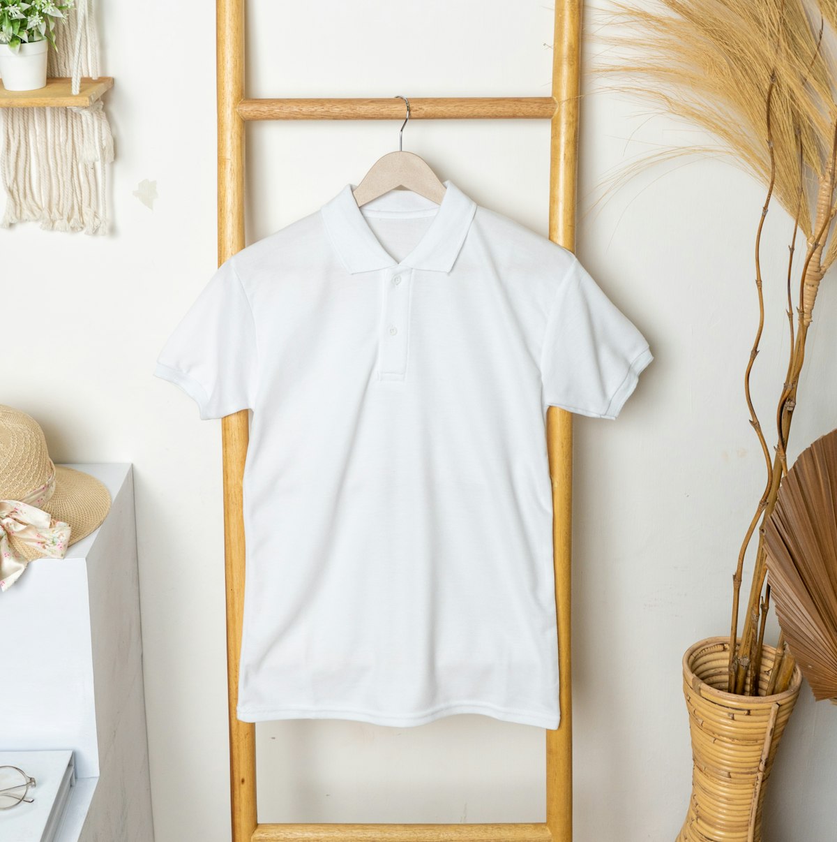 A plain white polo shirt hanging on display