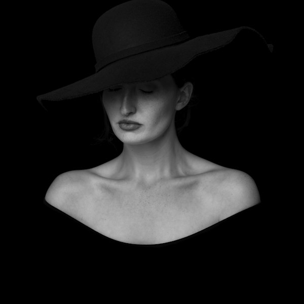 A woman wearing a black wide-brim hat