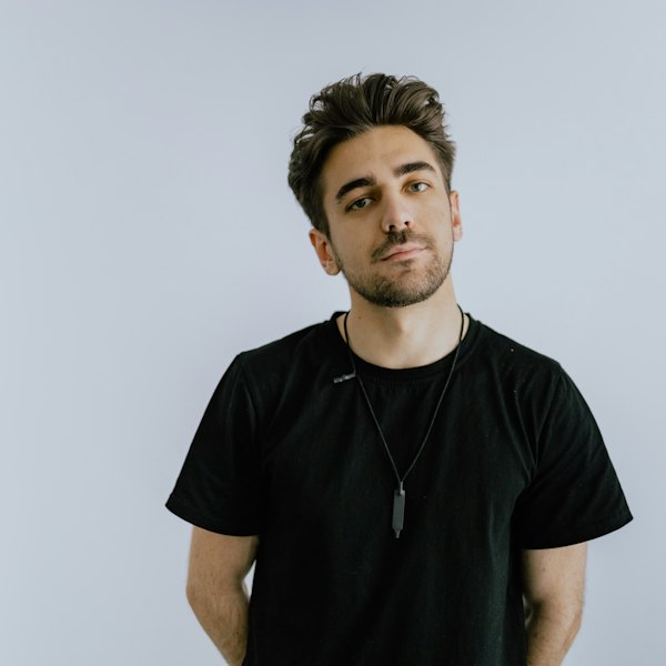 A man wearing a plain black t-shirt